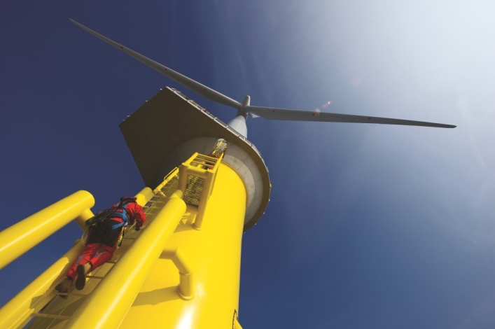 Man climbing wind turbine