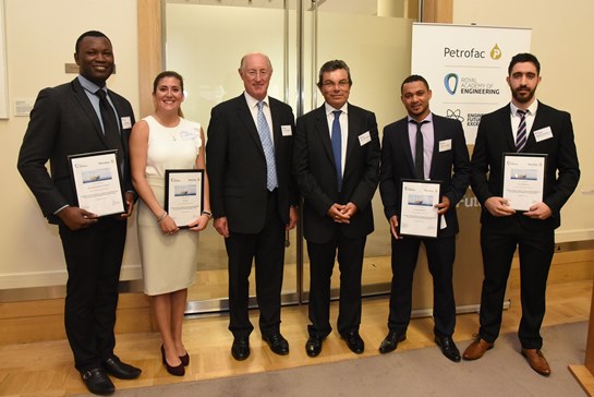 Graduates standing with their certificates